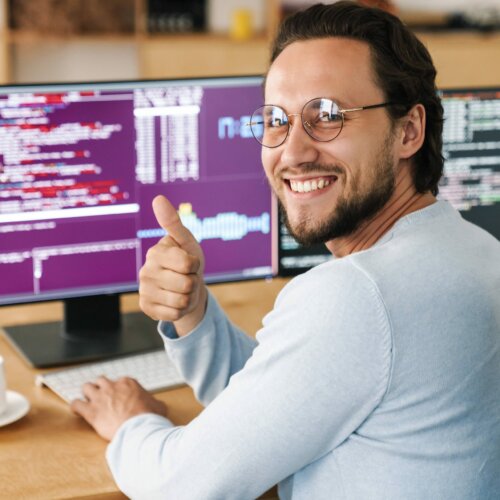 image-of-programmer-man-showing-thumb-up-while-wor-NB7CNRN-min-scaled-1